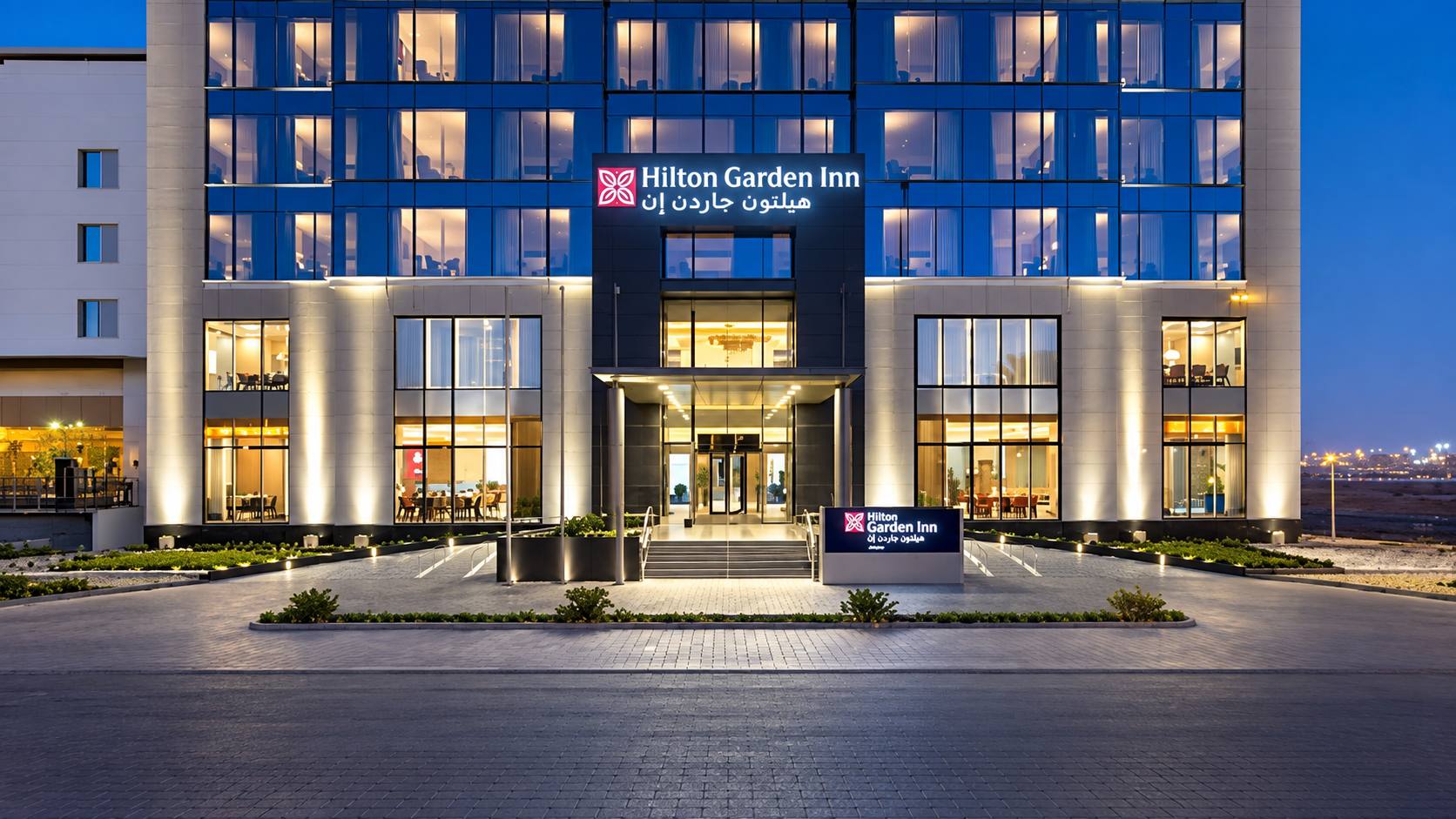Hilton Garden Inn Tabuk hotel exterior illuminated at night in Saudi Arabia