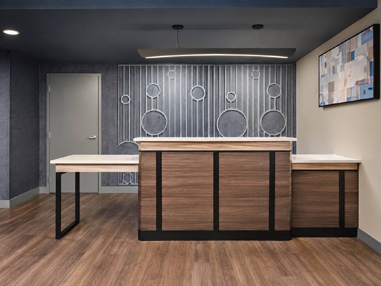 Hyatt Studios reception desk with dark feature wall