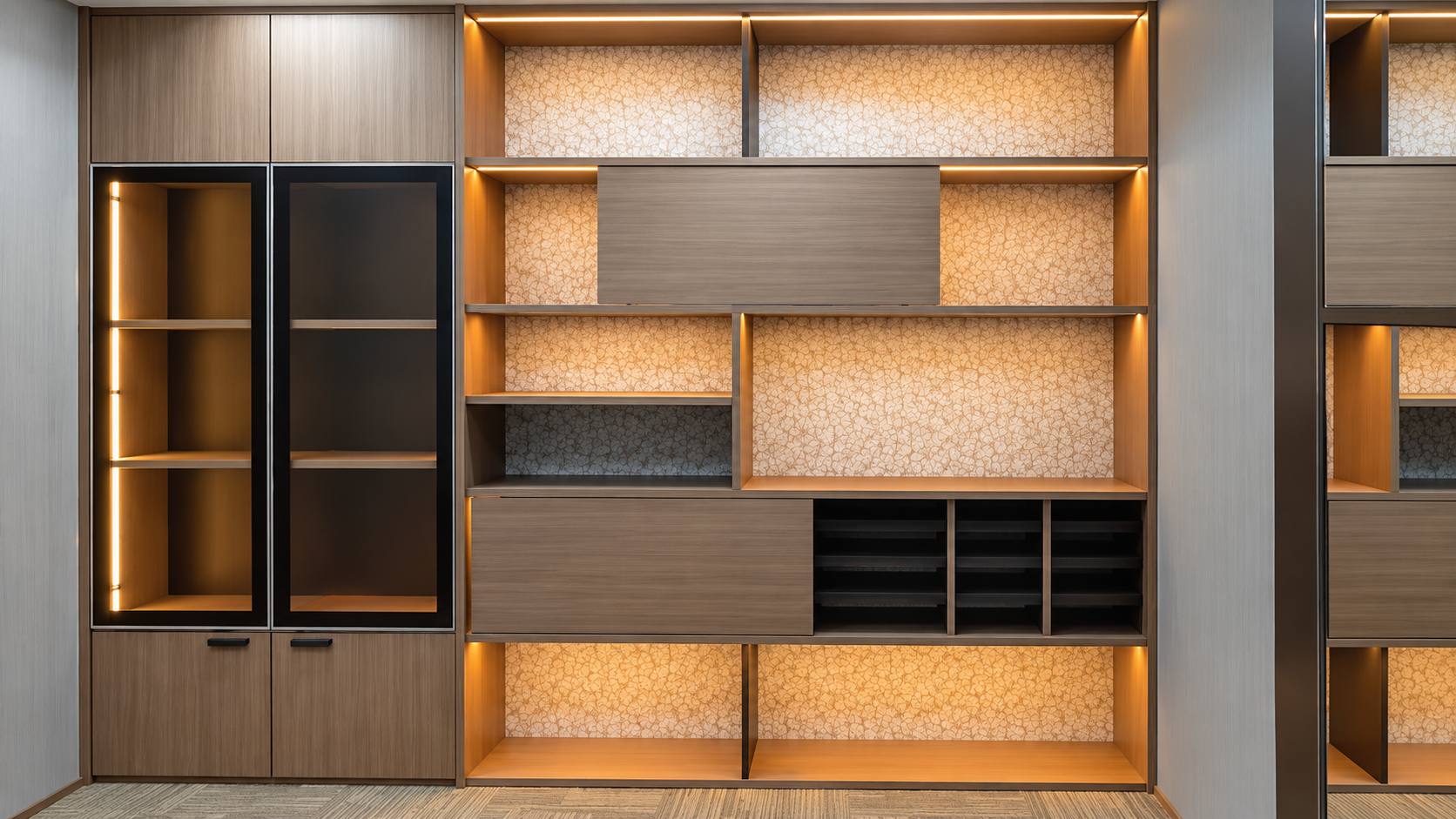 Jeff Office timber cabinetry with warm illuminated display shelving