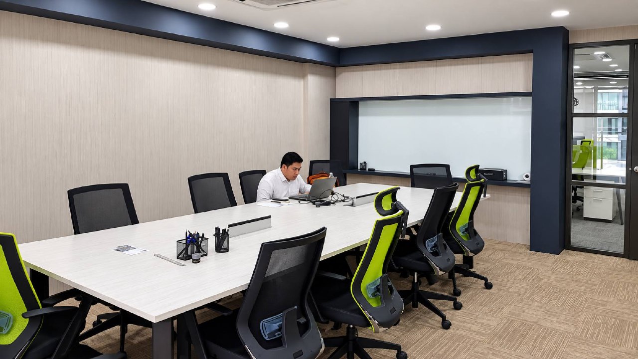 Jeff Office conference room with long meeting table and integrated display wall