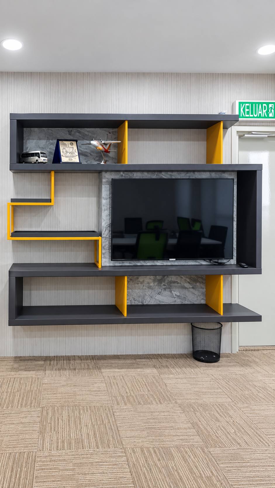 Jeff Office media wall with charcoal shelves and yellow accents
