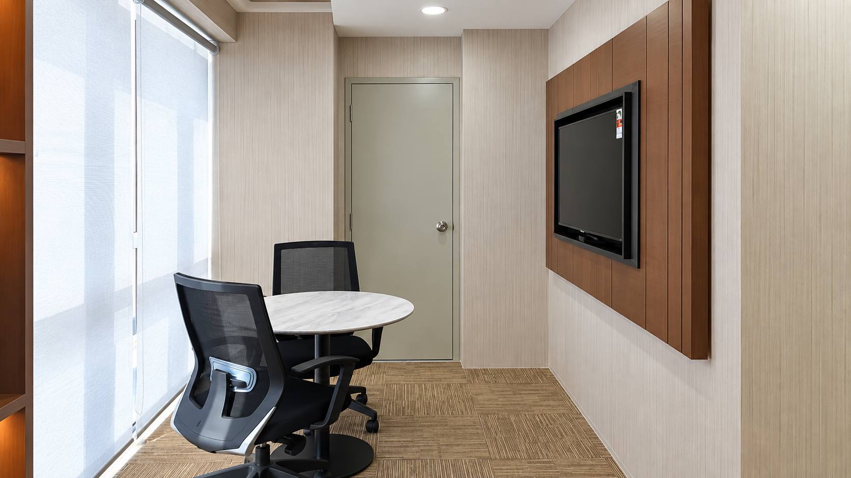 Jeff Office small meeting room with custom wall cabinetry and round table