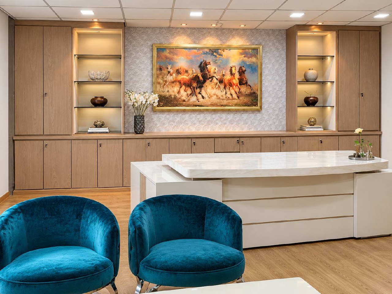 Client lounge with feature artwork, custom cabinetry and blue seating